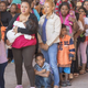 Central American migrants gathered inside and outside a church in Puebla, Mexico, on Saturday hoping to travel to the U.S. border